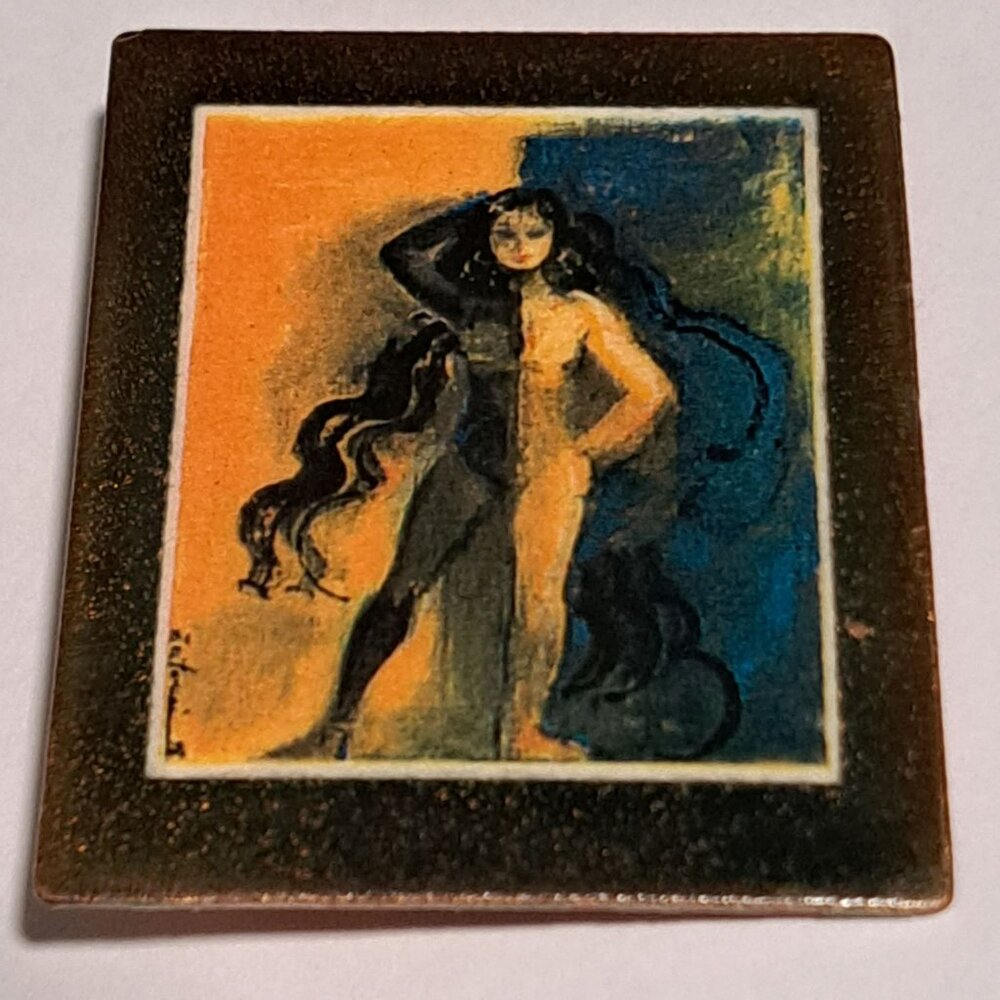 large rectangle brooch featuring a women in long black hair